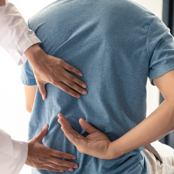 man showing doctor back pain