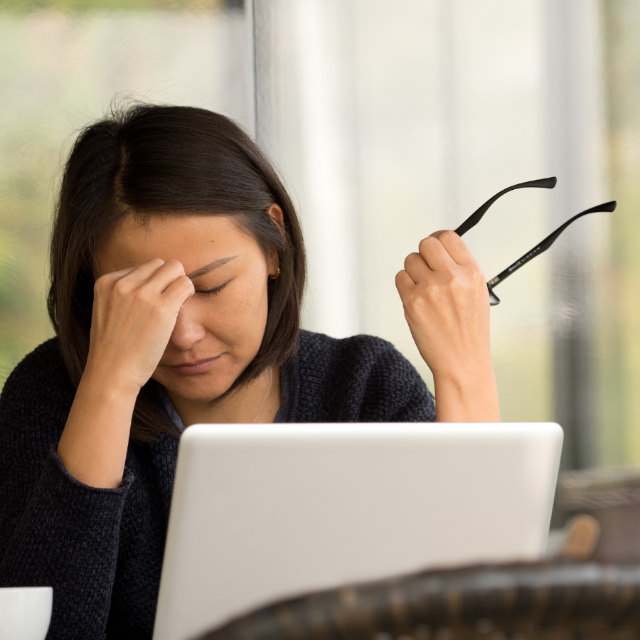 woman at computer with headaches