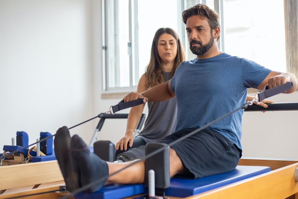 Man on pilates reformer physical therapy